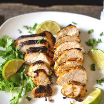Mouthwatering marinated chicken in dijon mustard, lime, cilantro and garlic have been grilled and ready for a summer BBQ