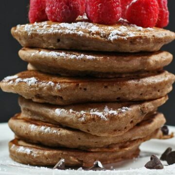 fluffy double chocolate pancakes topped with raspberries