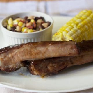 BBQ spicy ribs with bean salad and corn on the cob