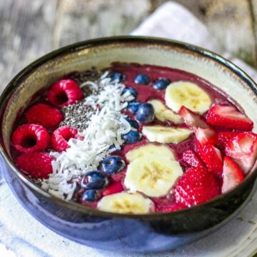 super easy and affordable acai bowls made at home. Topped with fresh fruit,homemade granola and coconut.