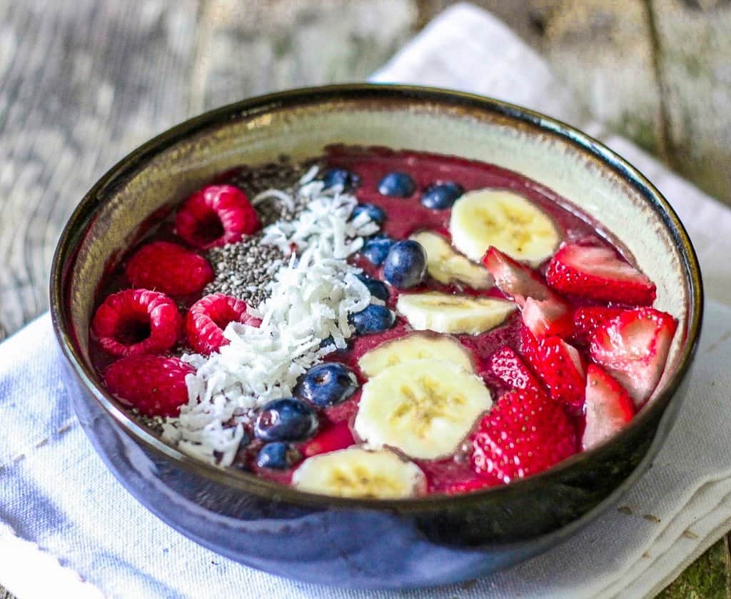 super easy and affordable acai bowls made at home. Topped with fresh fruit,homemade granola and coconut.