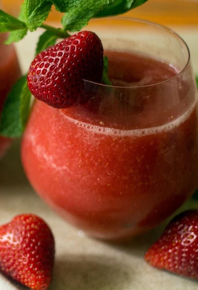 A side view strawberry vodka slush cocktail