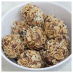 no bake coconut and date energy bites sitting in a white bowl.