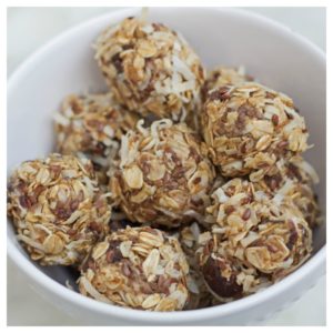 no bake coconut and date energy bites sitting in a white bowl.