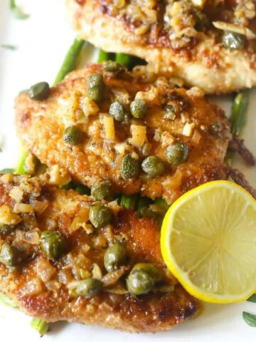 low carb lemon chicken piccata made with almond flour, white wine, shallots and capers.