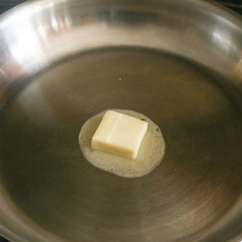 butter melting in pan to saute garlic for shrimp scampi