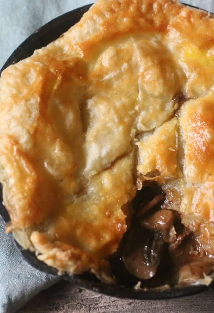 Hearty beef mushroom guinness pot pie and savory topping with tasty beef and gravy