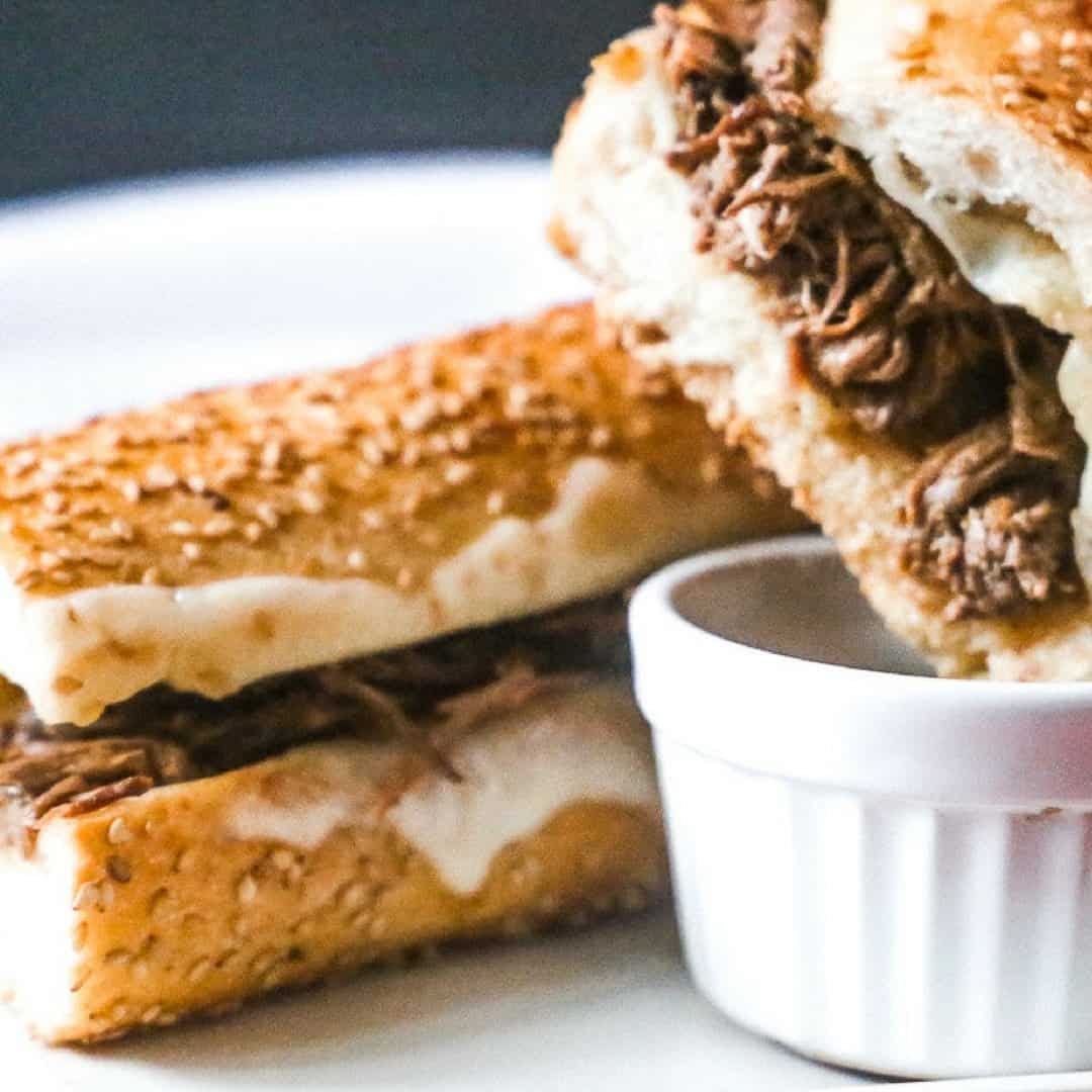 Tasty slow cooker french dip sandwich loaded with melted provolone cheese dipped in au jus sauce. All on a tasted hoagie