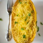 An aerial view of roasted spaghetti squash that has been pulled away from the shell and is spaghetti squash spaghetti.