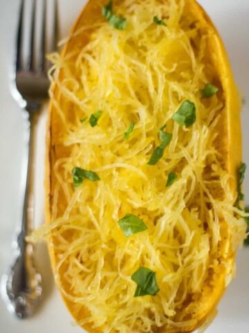 An aerial view of roasted spaghetti squash that has been pulled away from the shell and is spaghetti squash spaghetti.