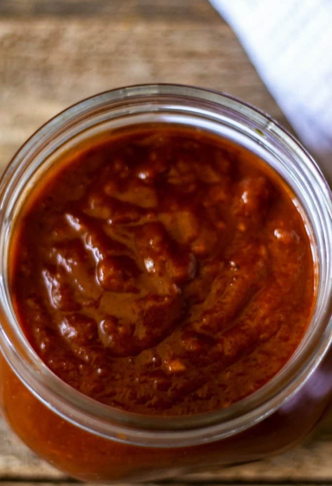 An aerial view of chipotle BBQ sauce in a mason jar.