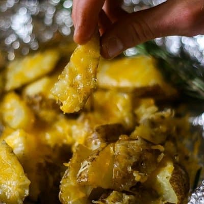 The cheesiest foil packet potatoes roasted on the grill 