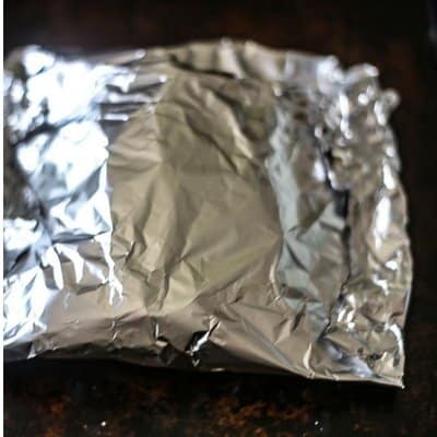 Foil packet potatoes wrapped and on the grill roasting to make the best grilled potatoes/