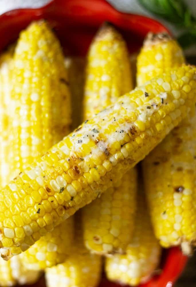 Grilled corn on the cob with melted basil parmesan butter