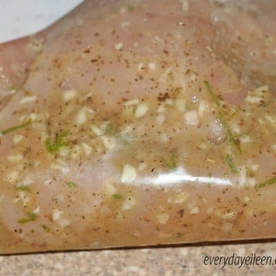 Chicken breasts marinating in Dijon Lime marinade in a large sealable plastic bag waiting to be grilled