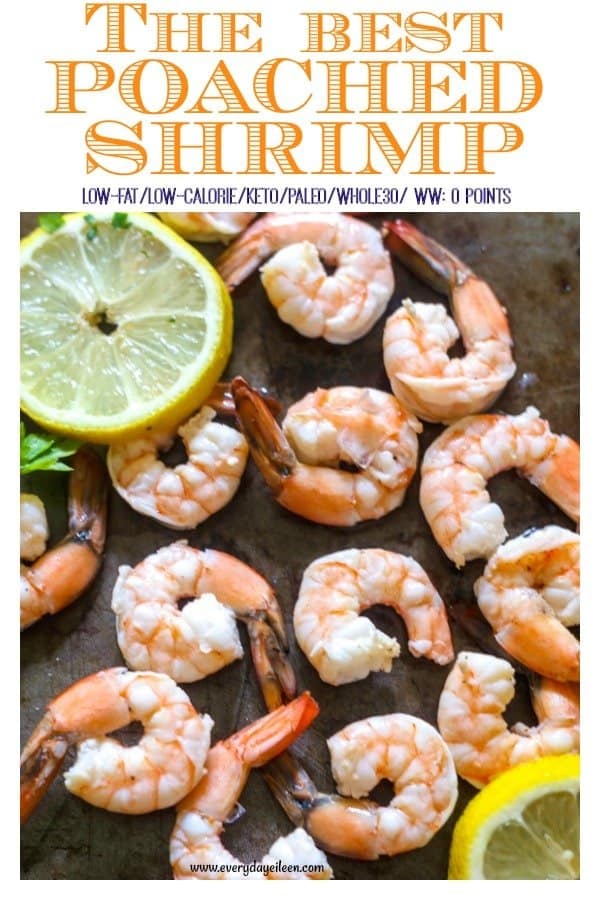 the best poached shrimp on a dark platter with lemon wedges around the shrimp.