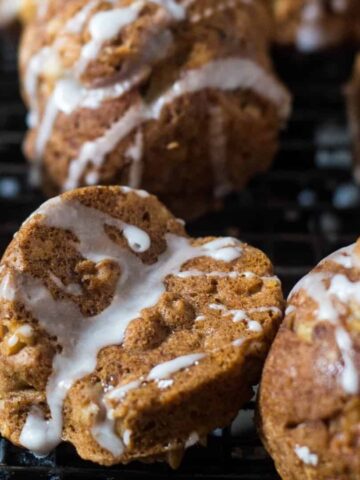 apple cakelets drizzled with maple cream on a cooling rack