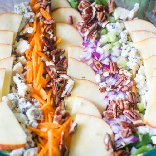 Apple pecan salad with crumbled blue cheese, shredded carrots, sliced apples, and pecans
