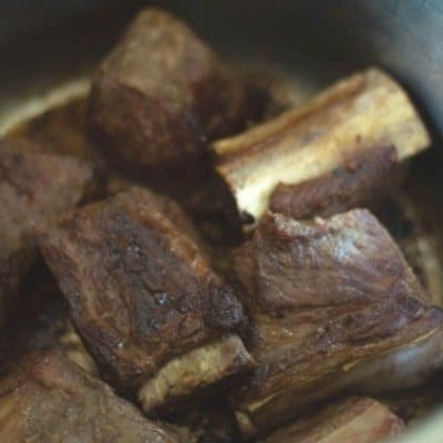 braised beef short ribs in the instant pot that have been seared and ready to be braised in beer for braised beef short ribs