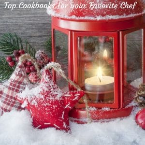 AfestiveChristmasscenewithsnowontheground,alanternandornamentsforgiftsfortopcookbooks