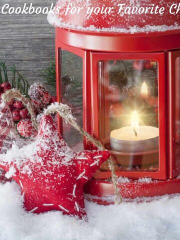 AfestiveChristmasscenewithsnowontheground,alanternandornamentsforgiftsfortopcookbooks