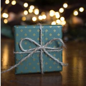 A present wrapped in pretty blue wrapping paper signifying unique kitchen gifts