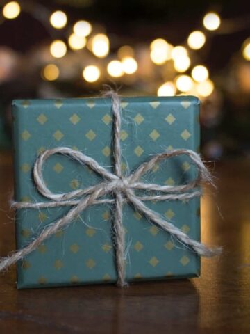 A present wrapped in pretty blue wrapping paper signifying unique kitchen gifts