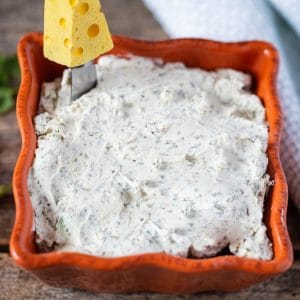 Homemade boursin cheese in a ceramic bowl.