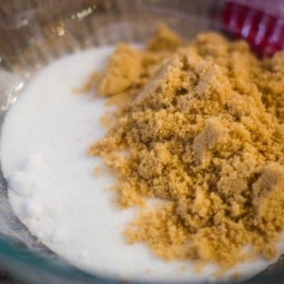 Getting the ingredients together for Chocolate Crinkle Cookies with white and light brown sugar in a large bowl.