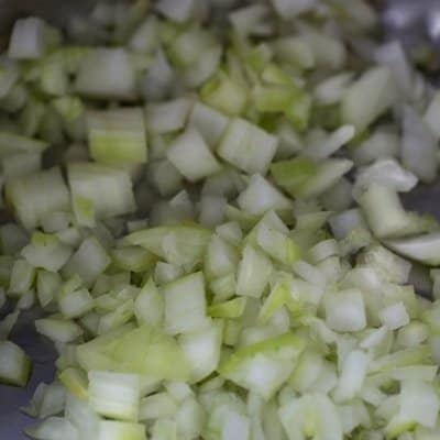 diced onions in olive oil spray in the instant pot sauteing to make chicken cacciatore.
