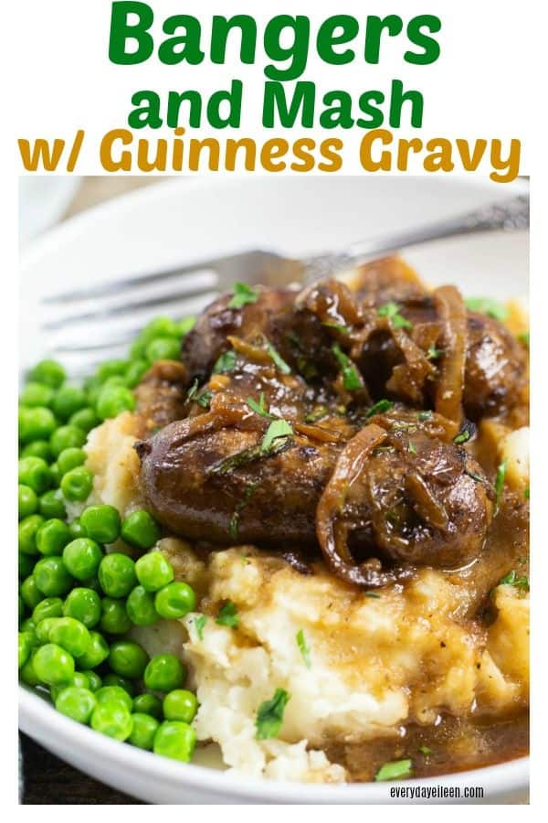 Delicious Irish Bangers with caramelized onions and Guinness gravy over mashed potatoes and green peas.