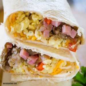 Tasty breakfast burritos made with ham and cheese ready stacked and ready to be eaten.