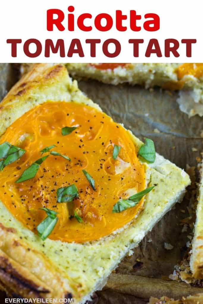 a tasty slice of ricotta tomato tart on a dark platter.