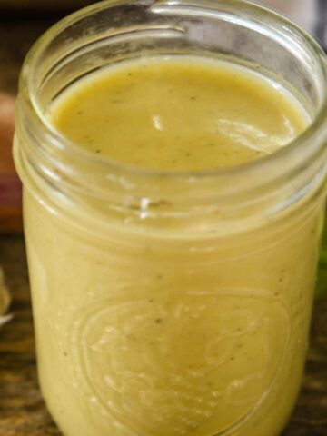 Delicious homemade champagne vinaigrette in a clear mason jar.