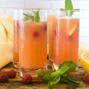 refreshing summer punch in glasses garnished with mint and fresh fruit