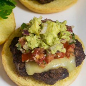 Delicious taco burgers topped with pepper jack cheese, pico de gallo, and guacamole!