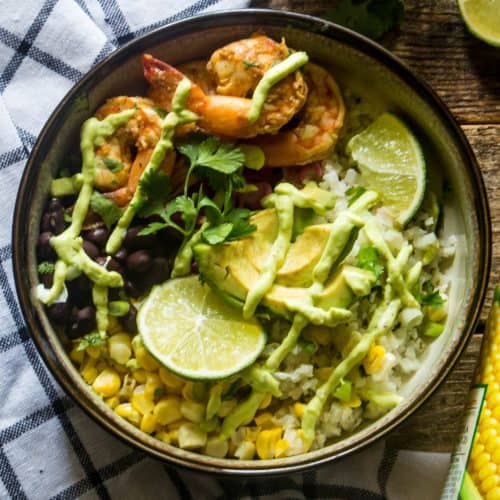 Delicious Baja Shrimp Bowl with cauliflower rice, corn, cabbage and avocado yogurt sauce