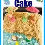 A festive cake decorated with a beach then with graham cracker sand, teddy graham people on candy blankets