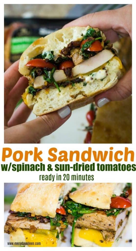 pork loin sandwich with spinach and sun-dried tomatoes being held in two hands