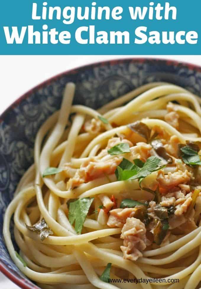 a blue ceramic bowl with pasta and clam sauce