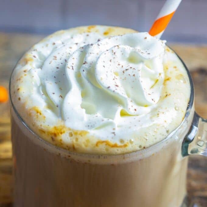 a delicious pumpkin spice latte with with cream , sprinkled with nutmeg