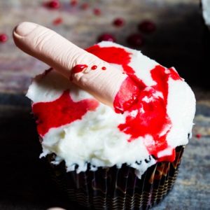 Festive Halloween topped cupcakes with edible blood and fingers
