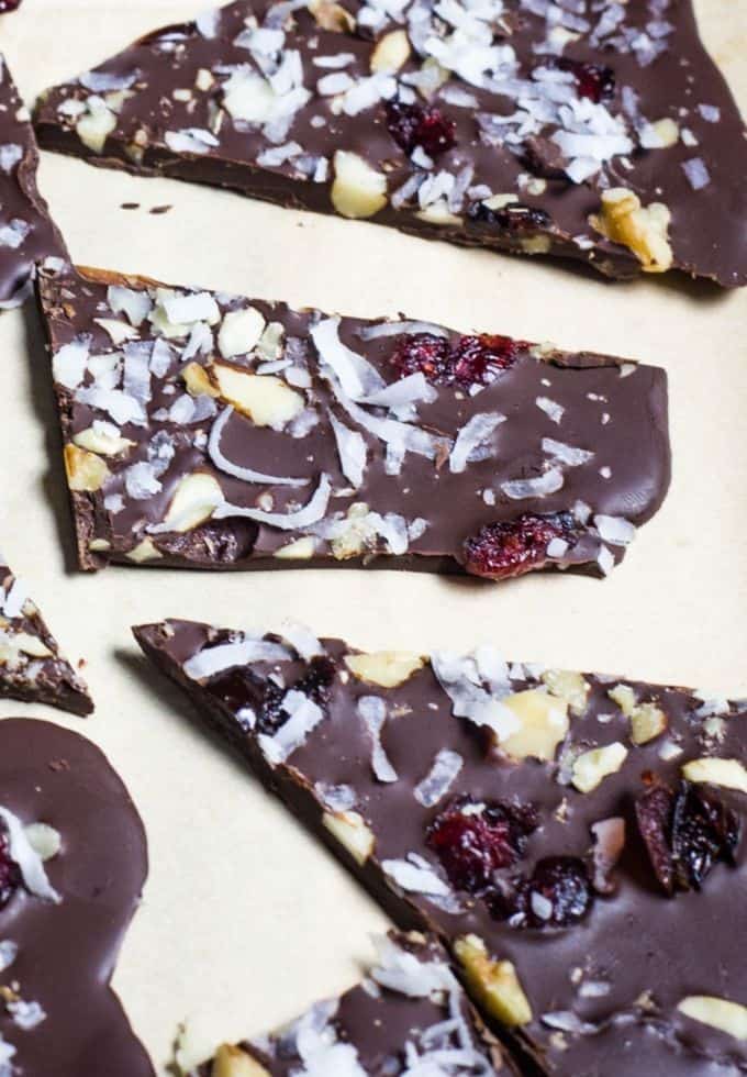 Chocolate pieces topped with cranberries, nuts, and chia seed