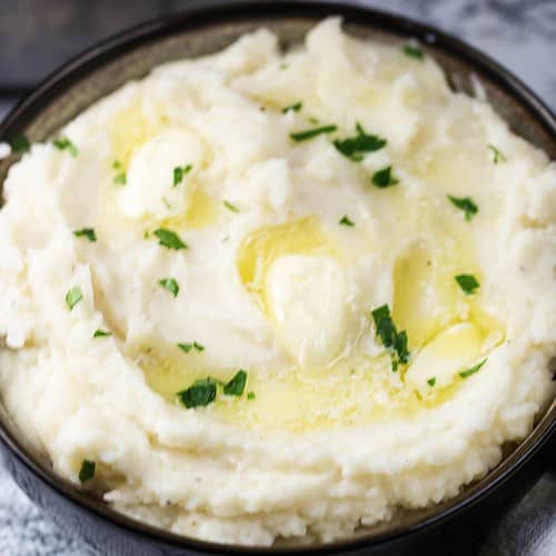 Warm Creamy Mashed Potatoes with melting butter that were made in the Instant Pot.