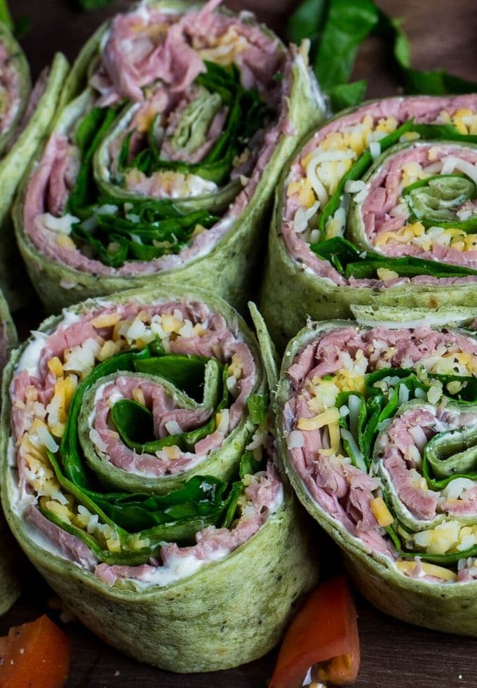 a few tortilla roll ups sitting on a tray.