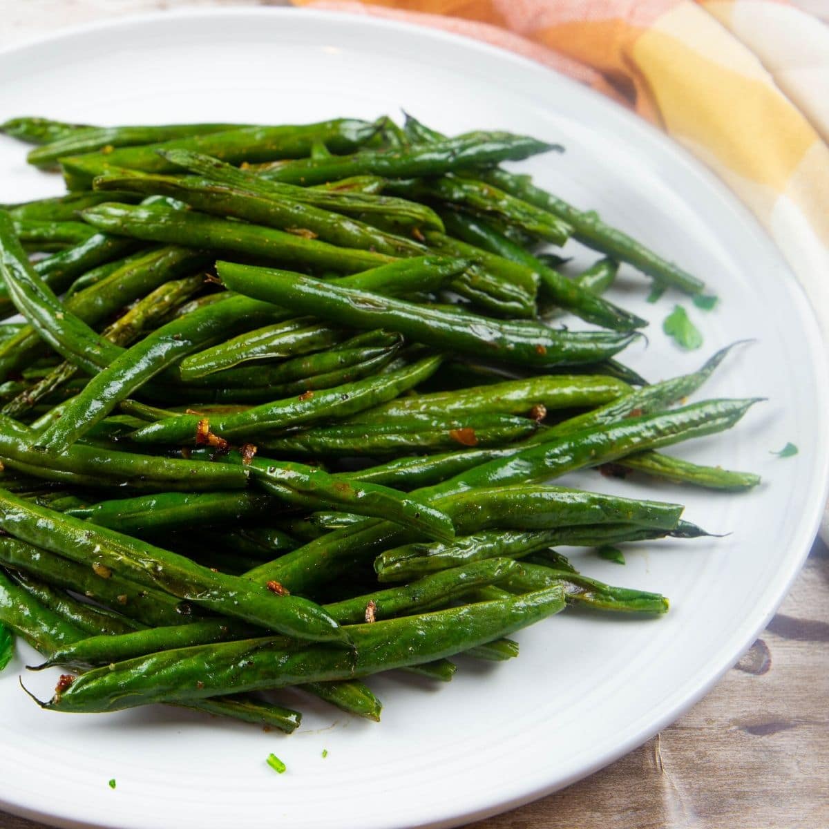 fresh oven roasted green beans on a white platter