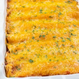 A casserole of beef enchiladas covered with melted cheese