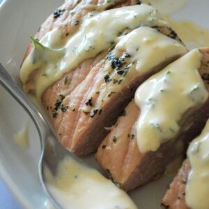 sliced roast pork with a lemon herb sauce