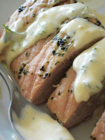 sliced roast pork with a lemon herb sauce