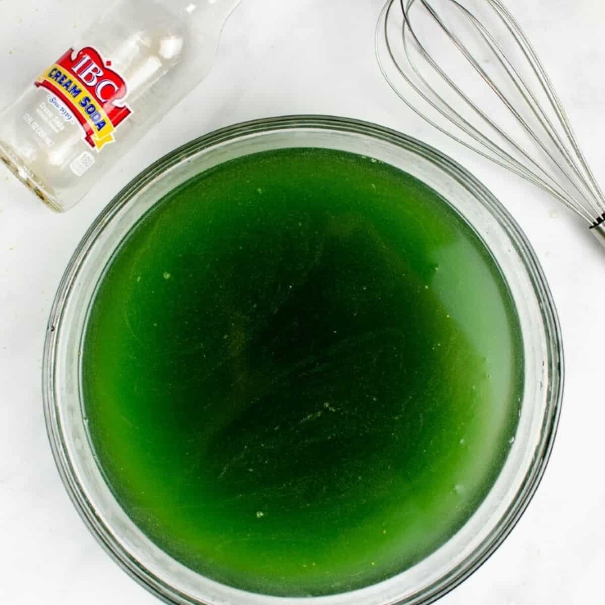 the ingredients to make a green festive Halloween cocktail